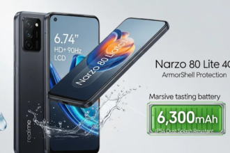 Realme Narzo 80 Lite 4G: Realme Narzo 80 Lite 4G स्मार्टफोन की एक विस्तृत छवि, जिसमें इसका बड़ा 6.74-इंच HD+ 90Hz LCD डिस्प्ले, IP54 धूल और स्प्लैश प्रतिरोध, आर्मरशेल प्रोटेक्शन, और एक विशाल 6,300mAh बैटरी दिखाई गई है। इसमें फोन का स्लीक, टिकाऊ डिज़ाइन भी प्रदर्शित किया गया है।